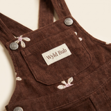 Cocoa corduroy baby pinafore dress with cross-back straps and embroidered flowers