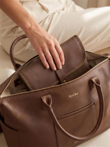 The Everyday Change Mat sliding into The Everyday Diaper Bag