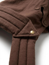 Close-up of quilted hood band and gold snap button detail