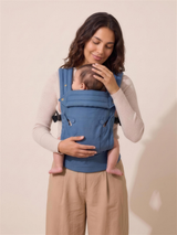 Mother looking down at her baby in the Wyld Bub Denim Blue baby carrier, studio