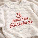 Close-up of red personalised Christmas embroidery and white speckled cotton knit