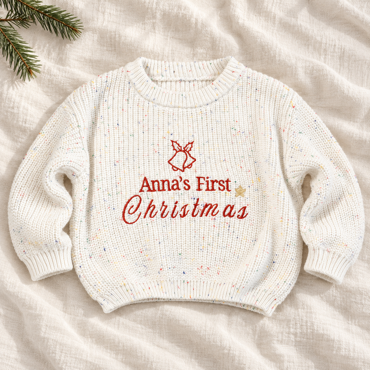 White speckled personalised first Christmas sweater with red embroidery on ivory linen