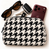 Wyld Bub black and ivory Houndstooth pouch with burgundy phone, keys and sunglasses
