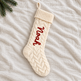 White cable-knit personalised Christmas stocking with Noah in red yarn